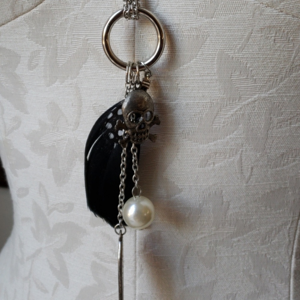 Long silver pendant necklace.